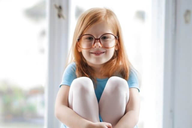 child girl redhead smiling glasses blue ballet dress 1000px.jpg